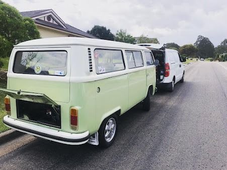 A Green And White Van Is Parked On The Side Of The Road Next To A White Van — SG Mobile Mechanic In Lake Macquarie, NSW