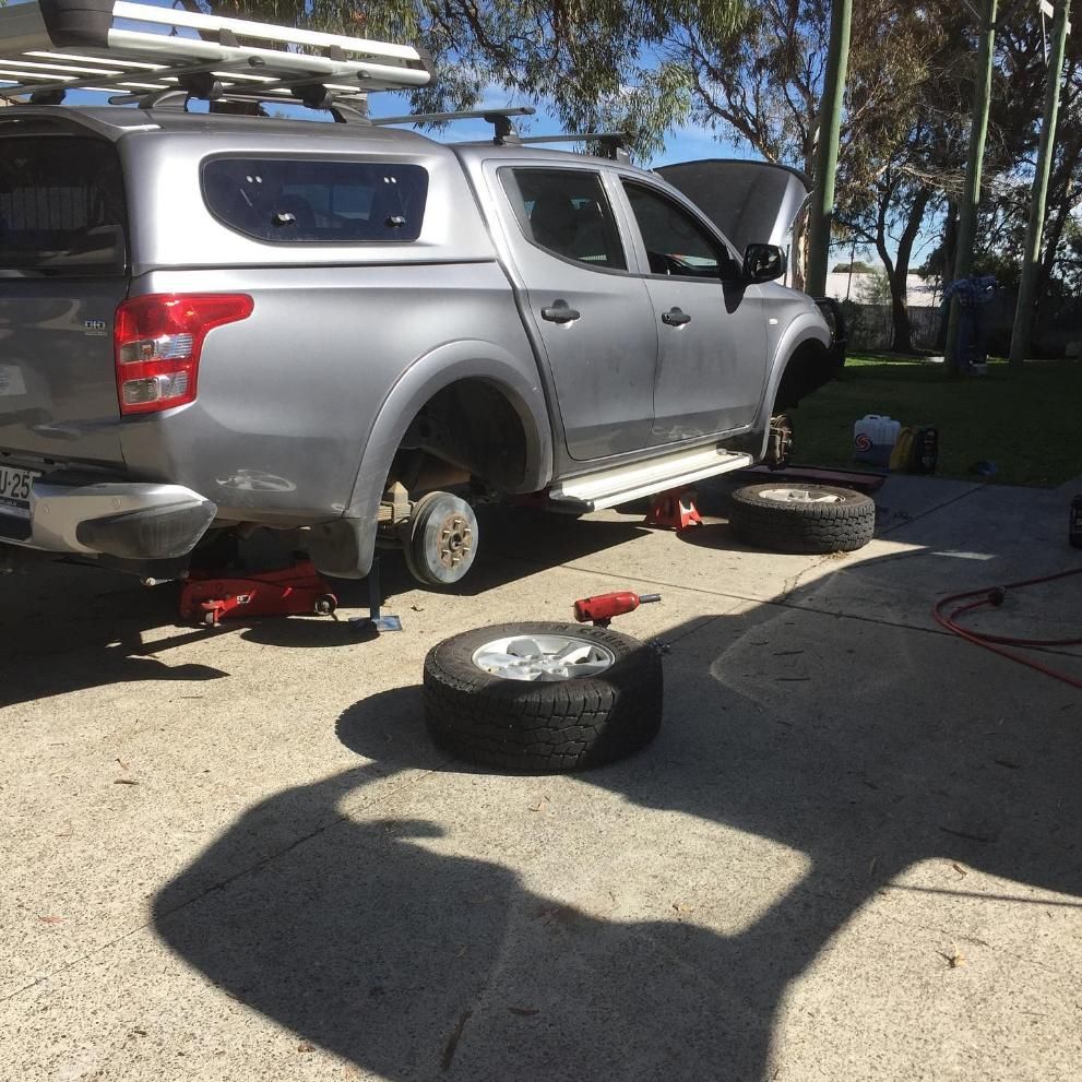 A Silver Truck Is Being Repaired In A Driveway — SG Mobile Mechanic In Lake Macquarie, NSW