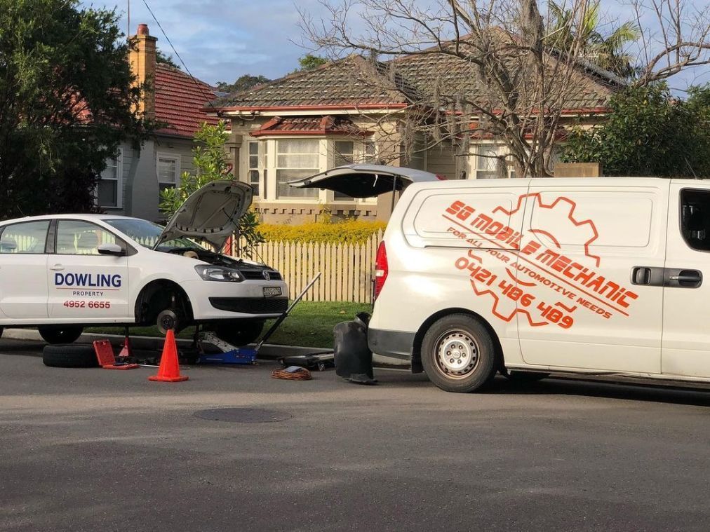 A White Van With The Word Mechanic On It Is Parked Next To A White Car — SG Mobile Mechanic In Newcastle, NSW