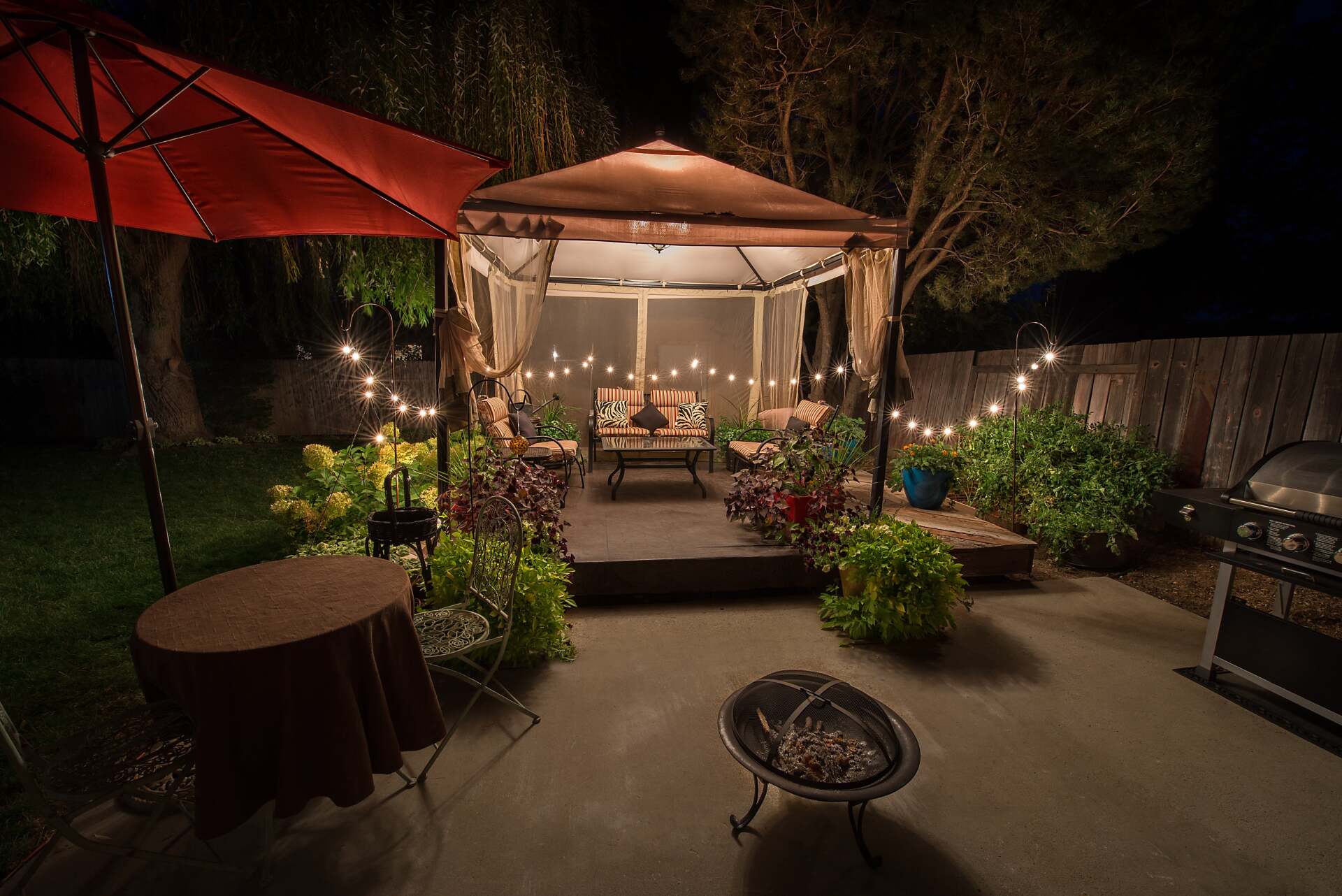 Concrete patio with raised stage area in Rancho Cucamonga backyard