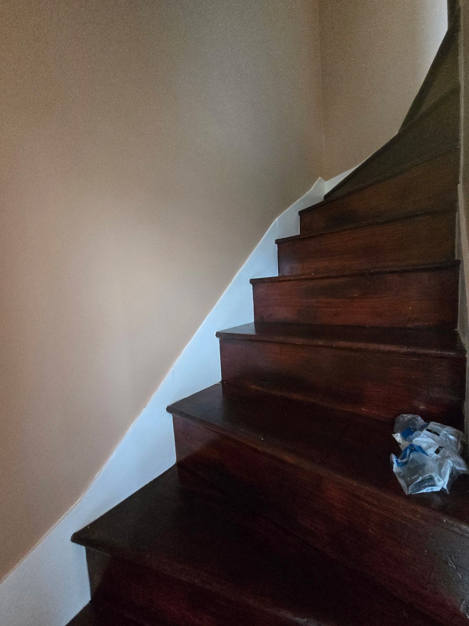 A close up of a wooden staircase in a house.