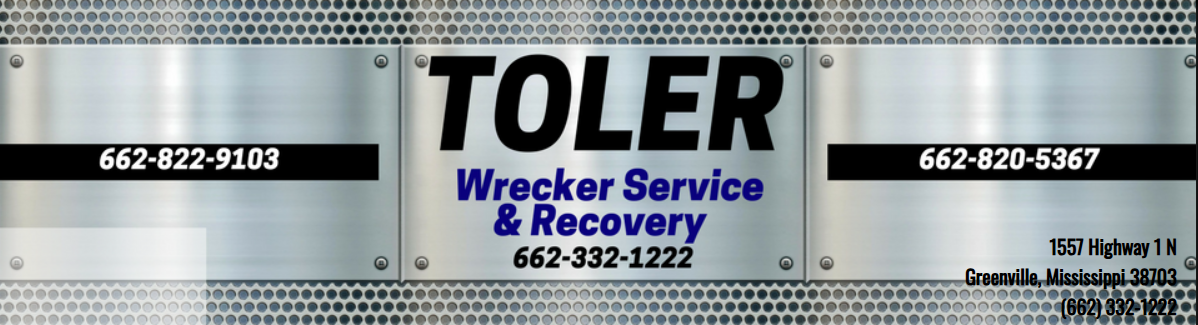 Metal trailer sign for Toler Wrecker Service & Recovery with phone numbers on black panels