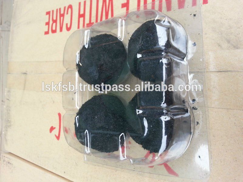 Four round, black objects in a clear plastic container; the container has the words 