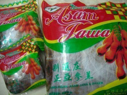 Bags of asam jawa (tamarind) fruit candy; red, green, and yellow packaging with tamarind fruit illustration.