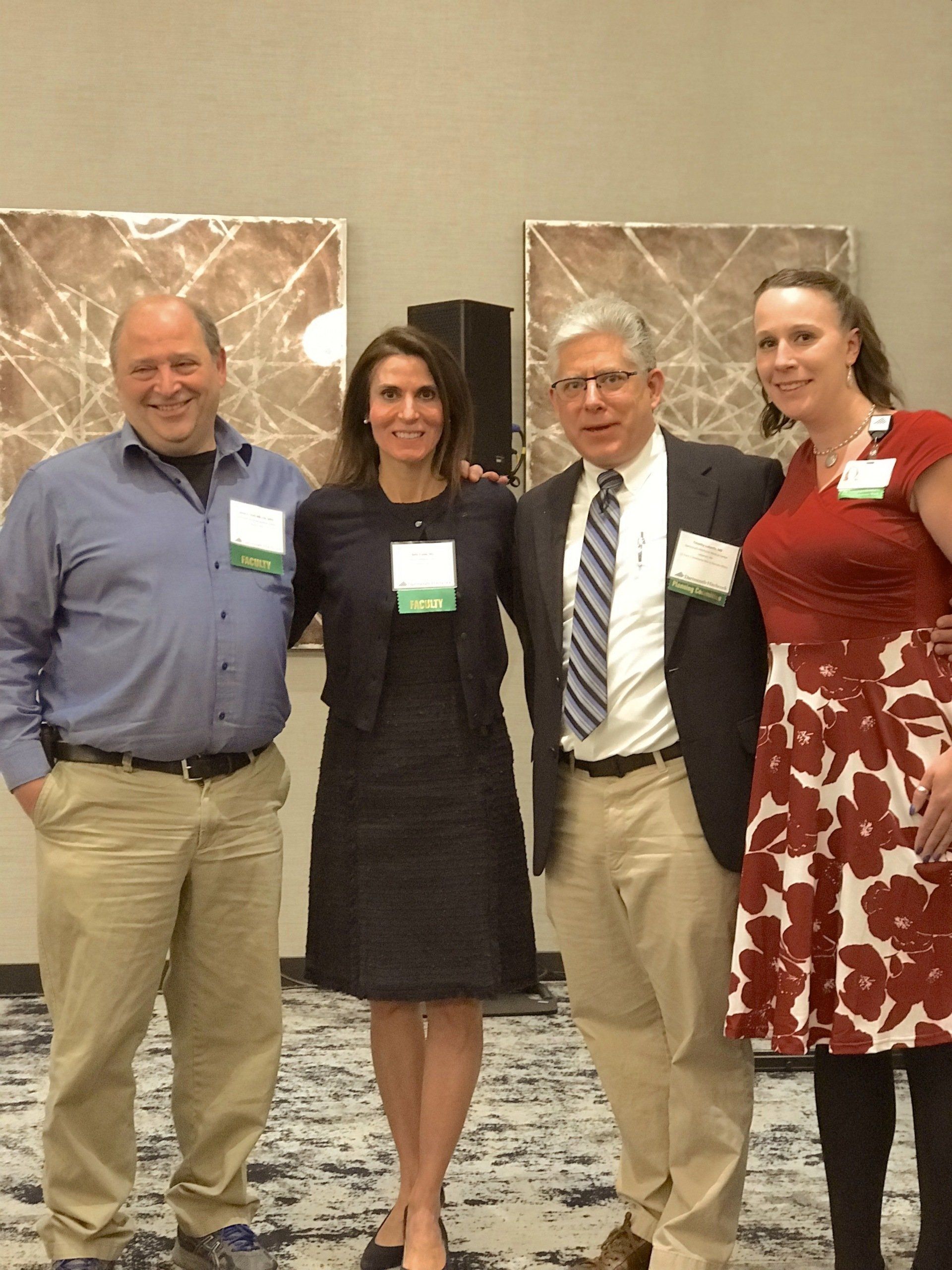 Dr. Beth Frates with colleagues speaking at a conference at Dartmouth Medical Center.