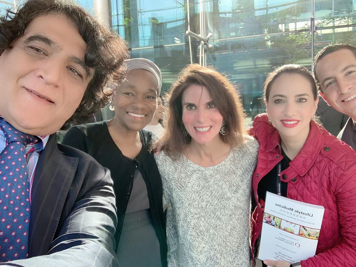 Dr. Beth Frates with colleagues at the Harvard Medical School CME course for leaders in surgery from around the world signing copies of her book The Lifestyle Medicine Handbook: An Introduction to the Power of Healthy Habits.