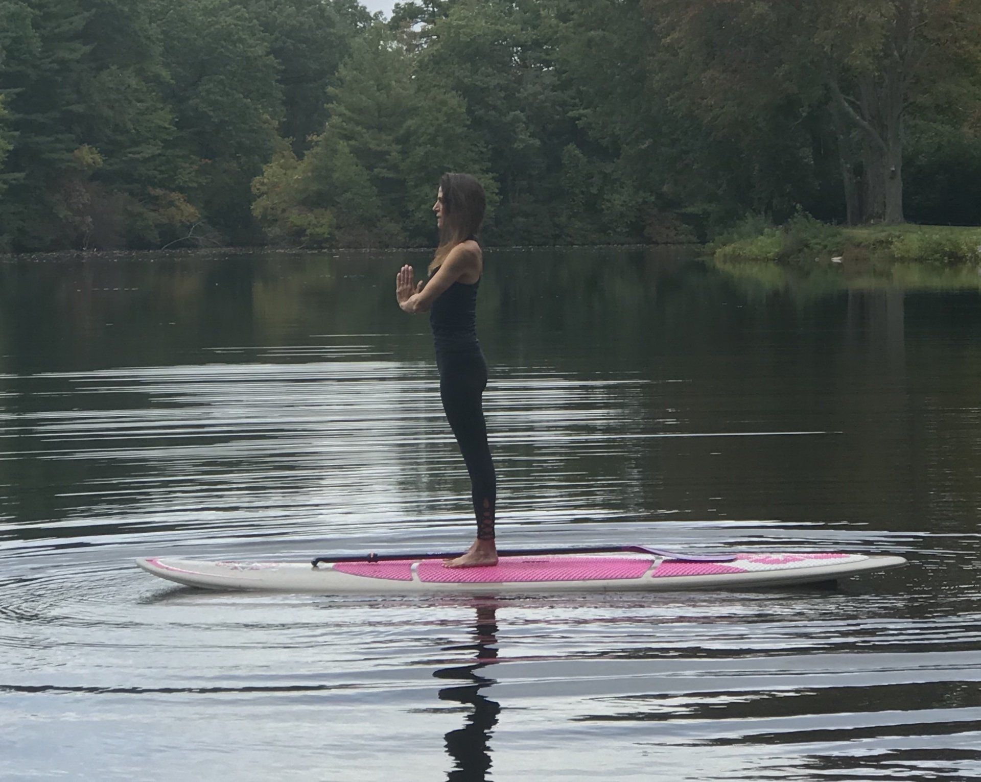 Beth Frates MD standing in a yoga pose on a paddleboard.