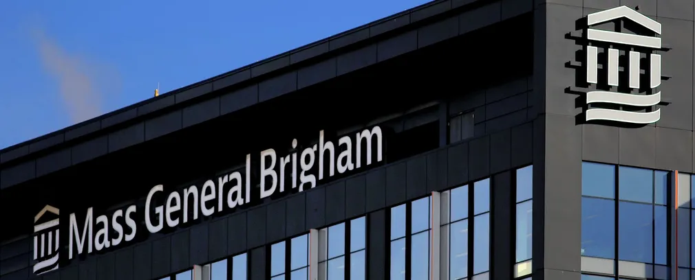 Mass General Brigham hospital building sign on a dark modern facade