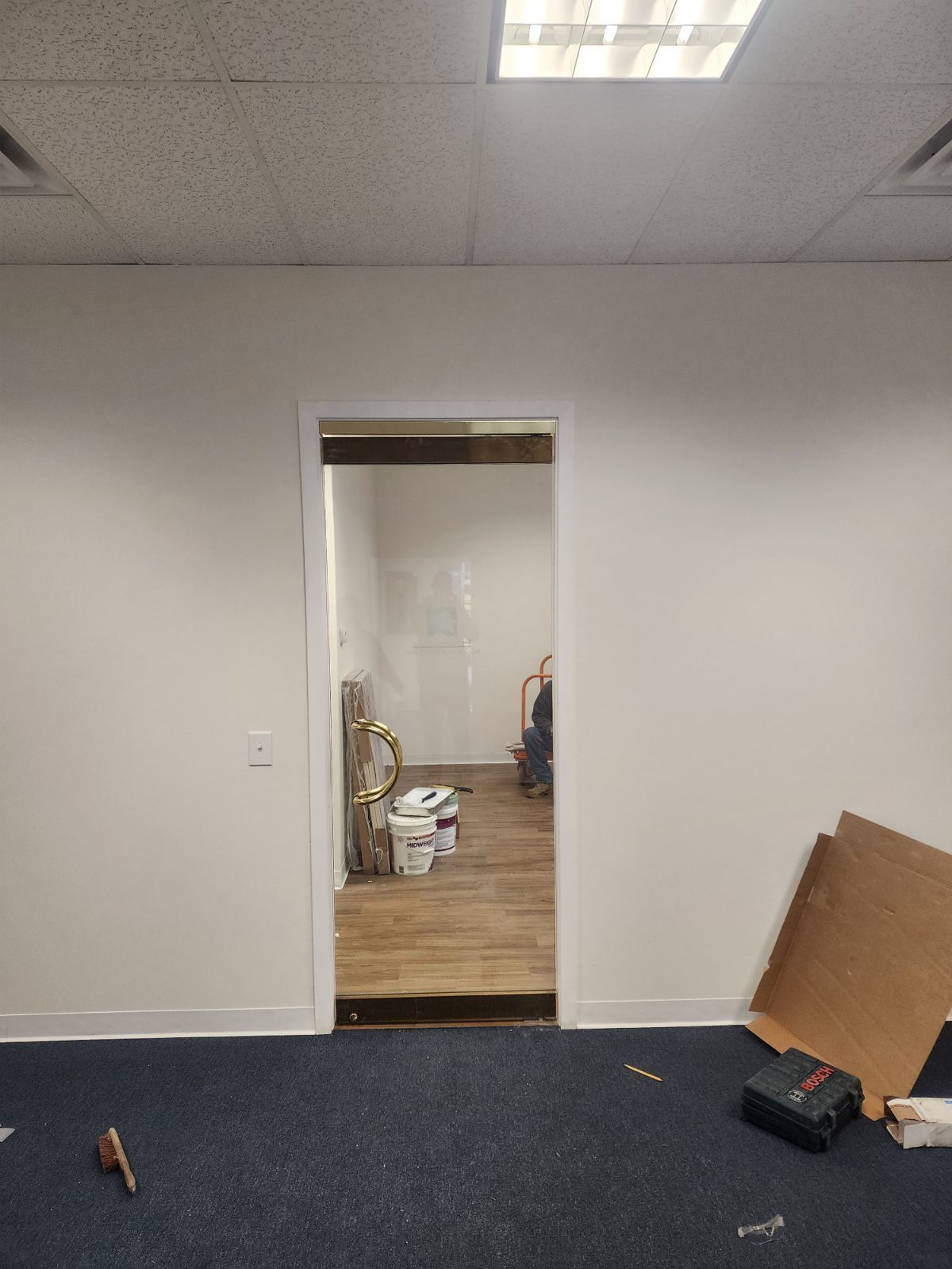 An empty room with a doorway leading to another room.