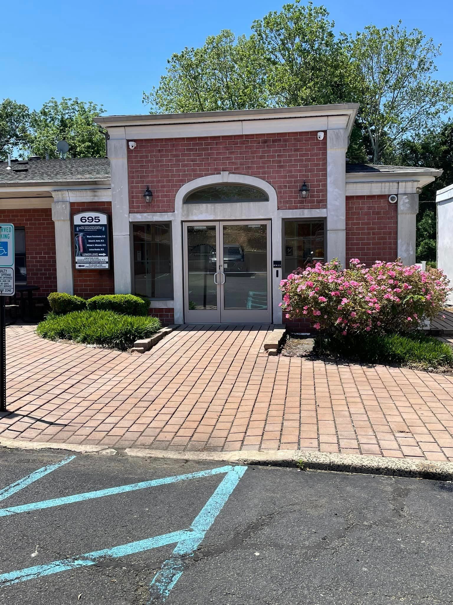 A brick building with a handicapped parking spot in front of it.