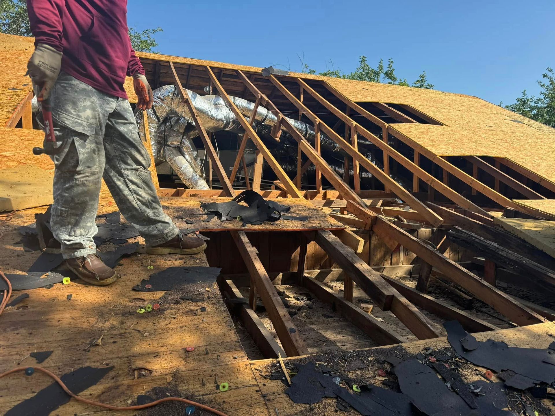 A man is standing on the roof of a building.
