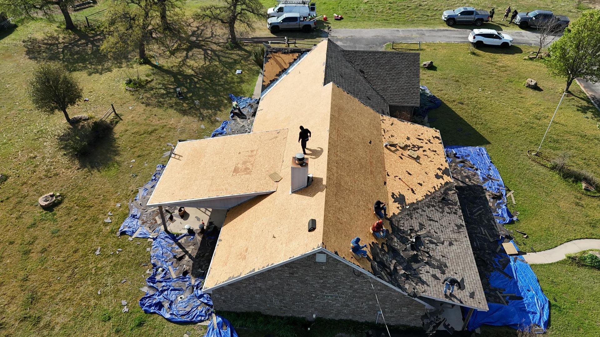 An aerial view of a roof being installed on a house.