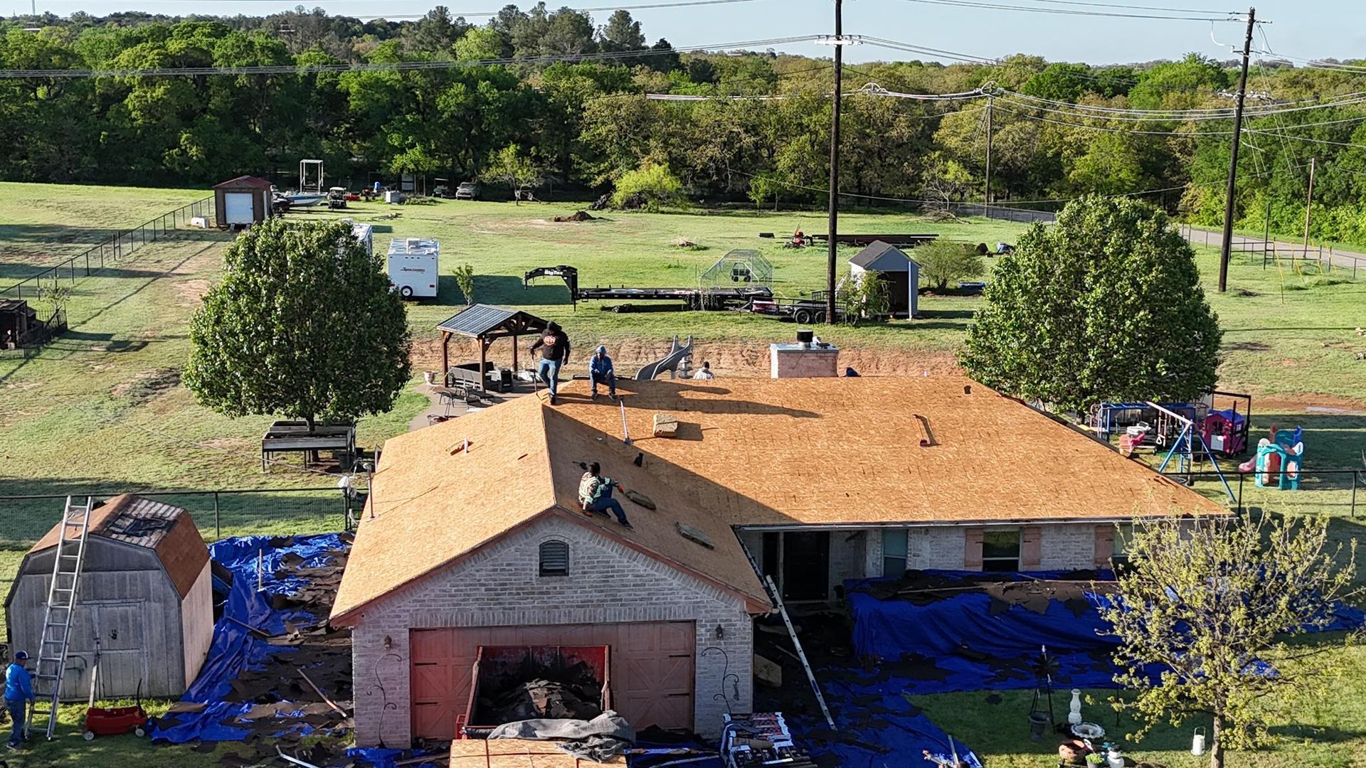 An aerial view of a house being remodeled with a new roof.