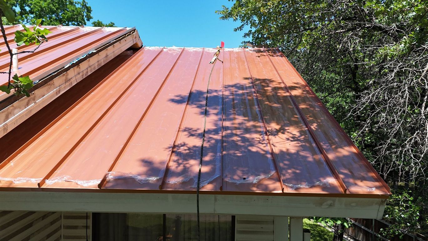 A copper roof is sitting on top of a house.