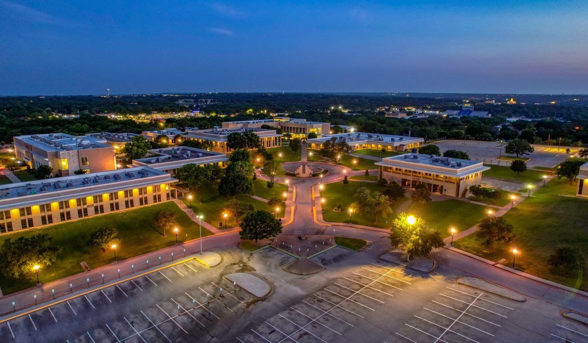 An aerial view of a college campus at night.