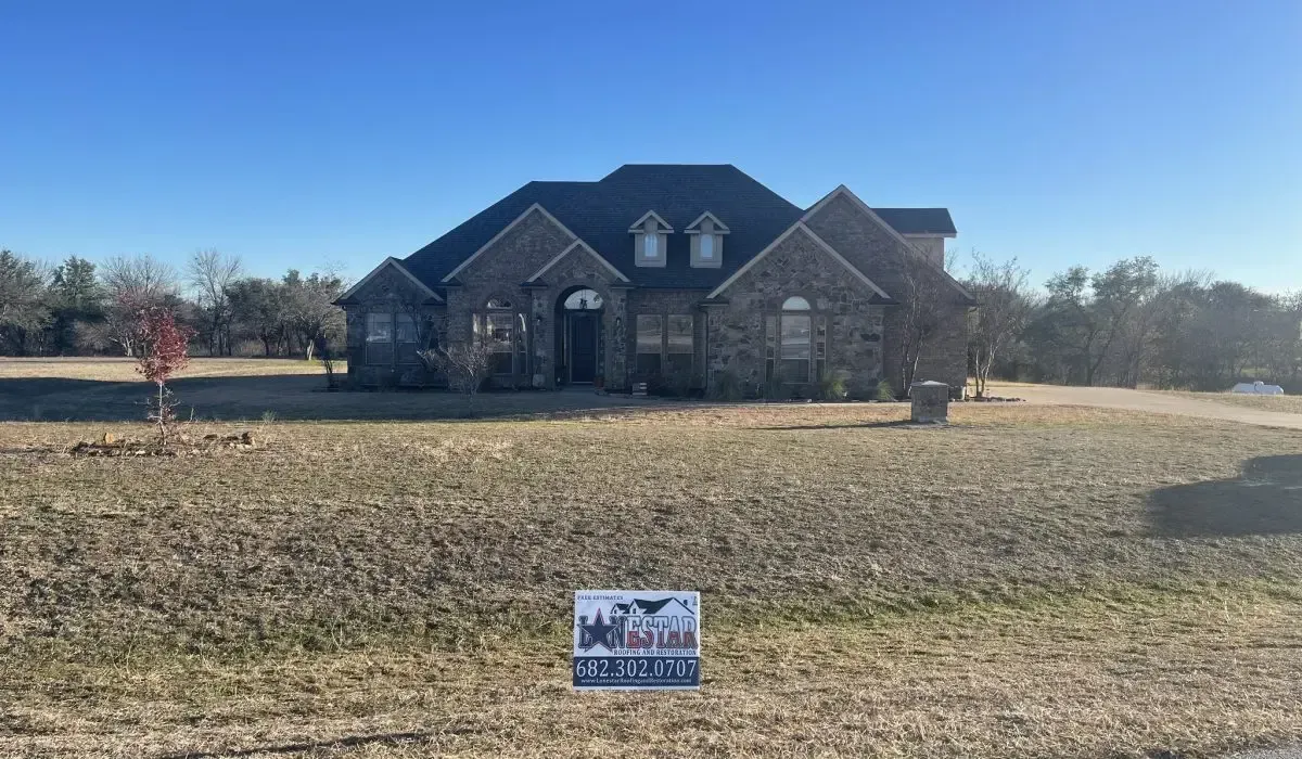 A large house with a sign in front of it.