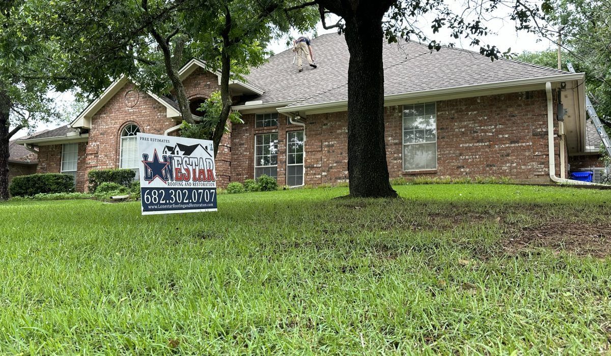 A house with a for sale sign in front of it.