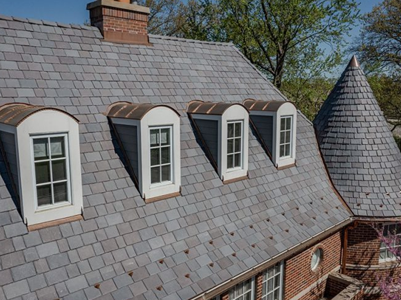 A house with a slate roof and arched windows