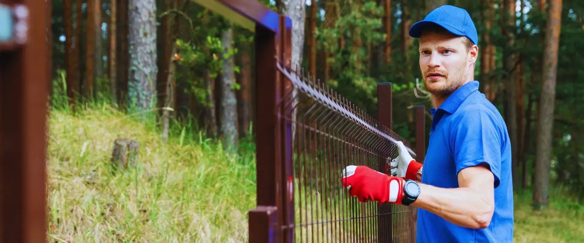 man installing chain link fence