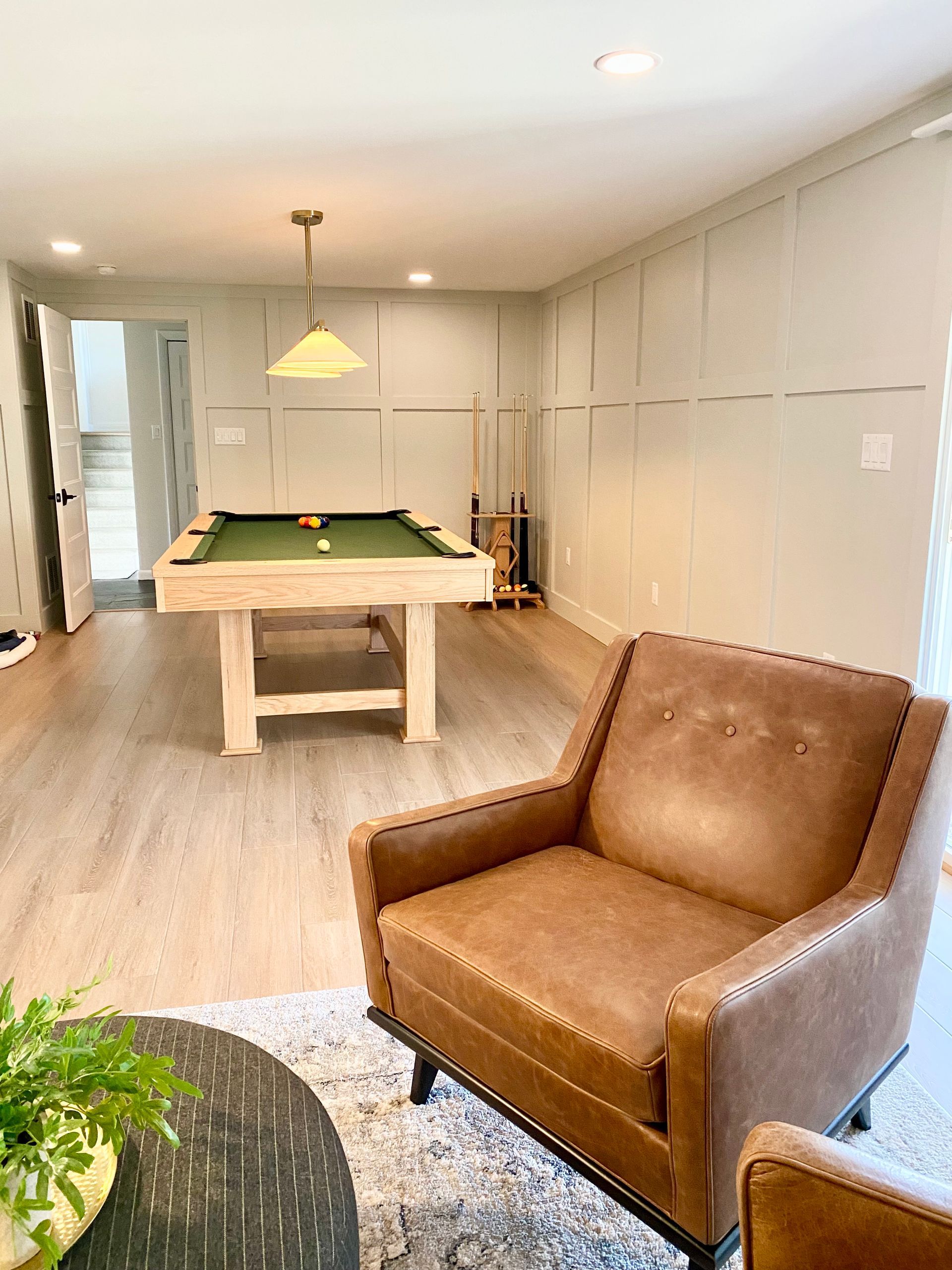 there is a pool table in the middle of the room .