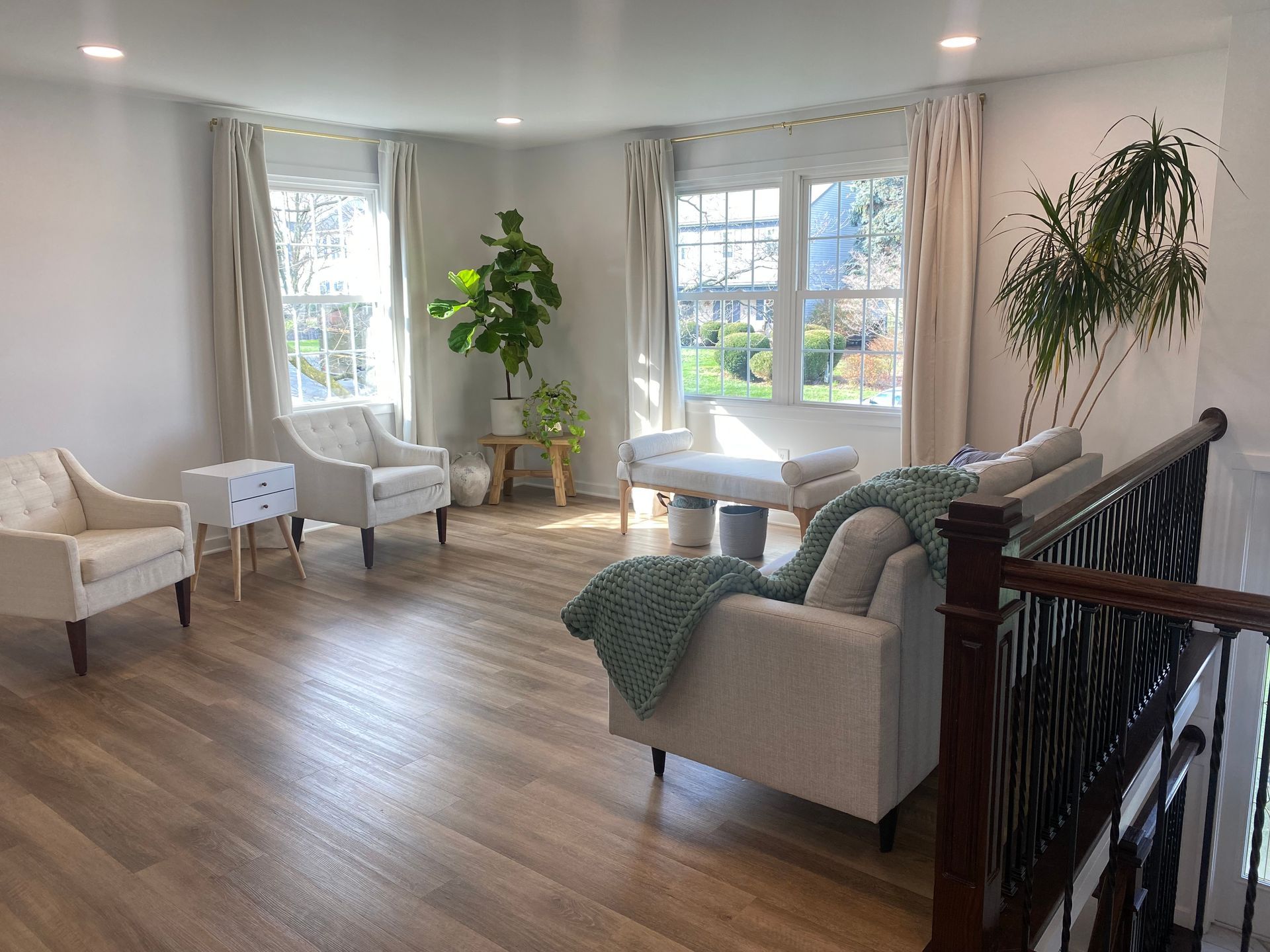 a living room renovation by Christy Martin Design Interiors, featuring a custom couch, chairs, and ottoman