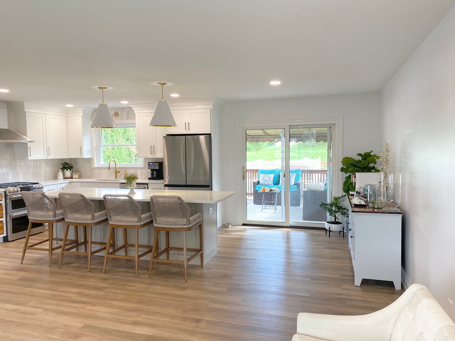 a  custom kitchen remodel in Lancaster PA with a large island and stools in a living room .