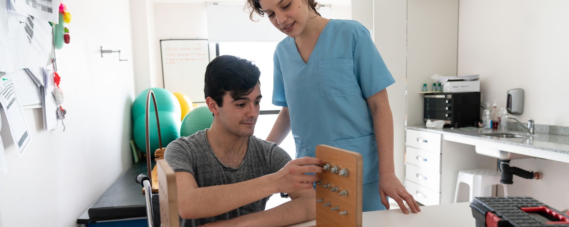 Female occupational therapist assisting a male patient