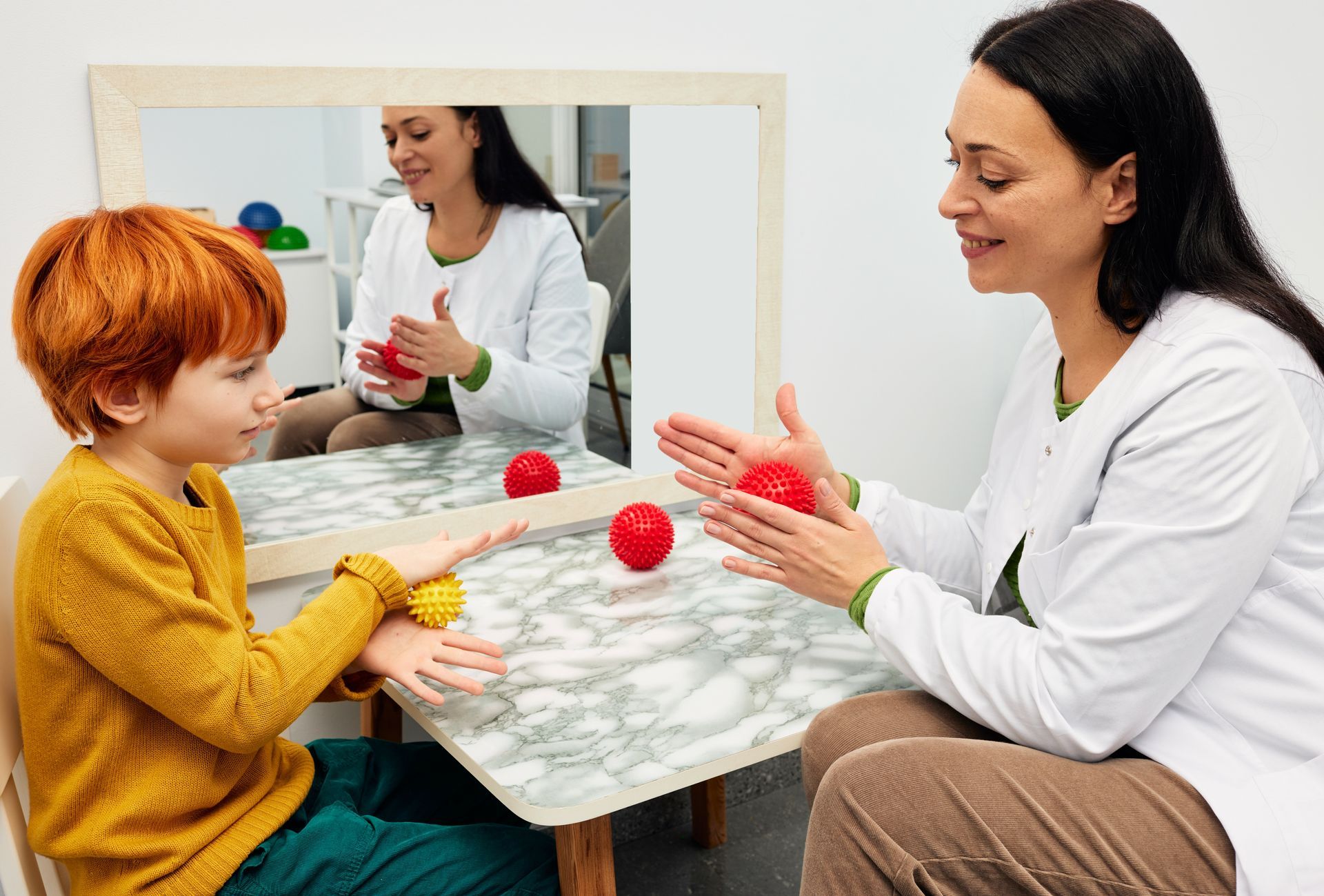 Occupational therapist working with child client using sensory tools