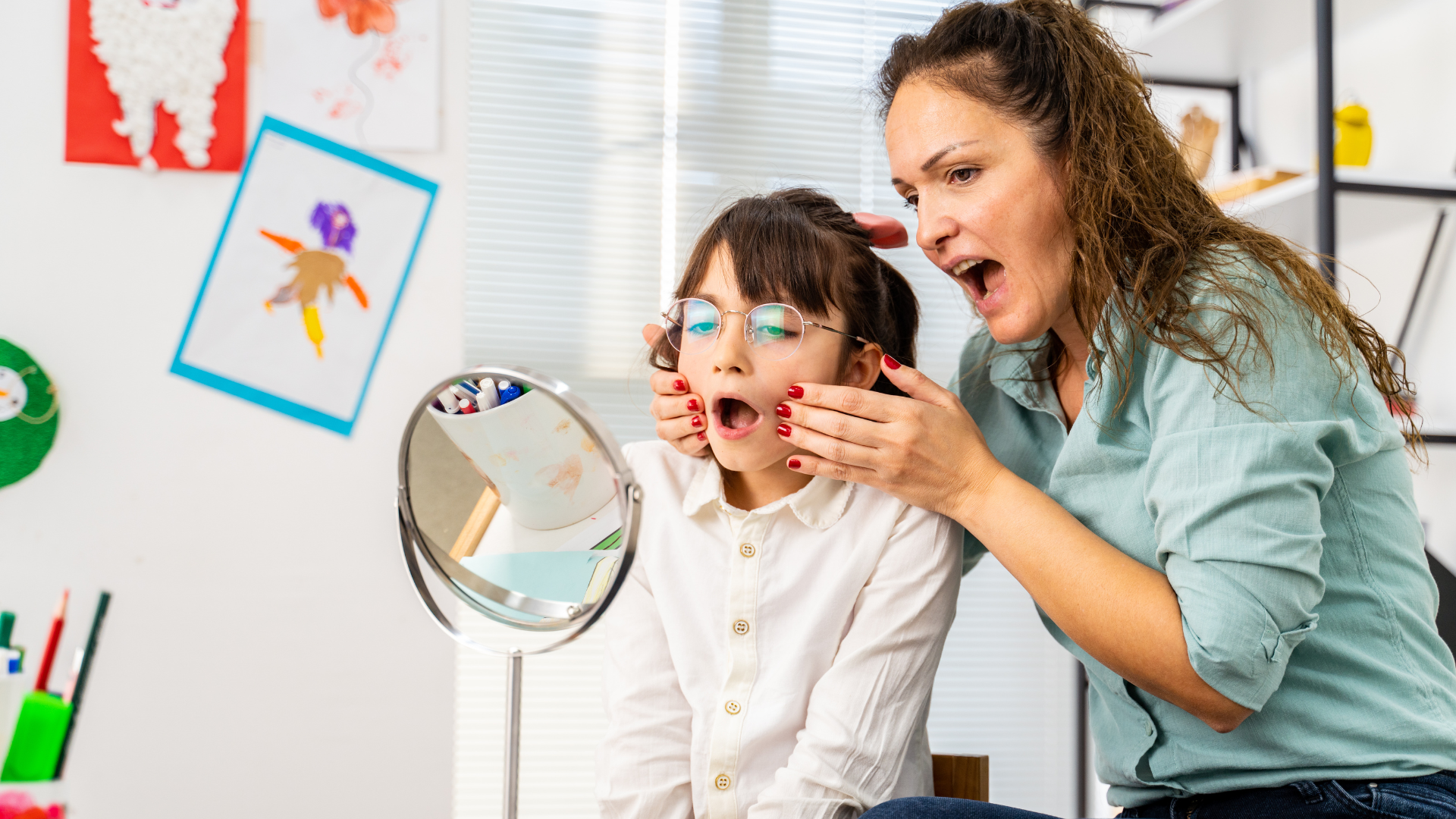 Speech pathologist helping young female patient
