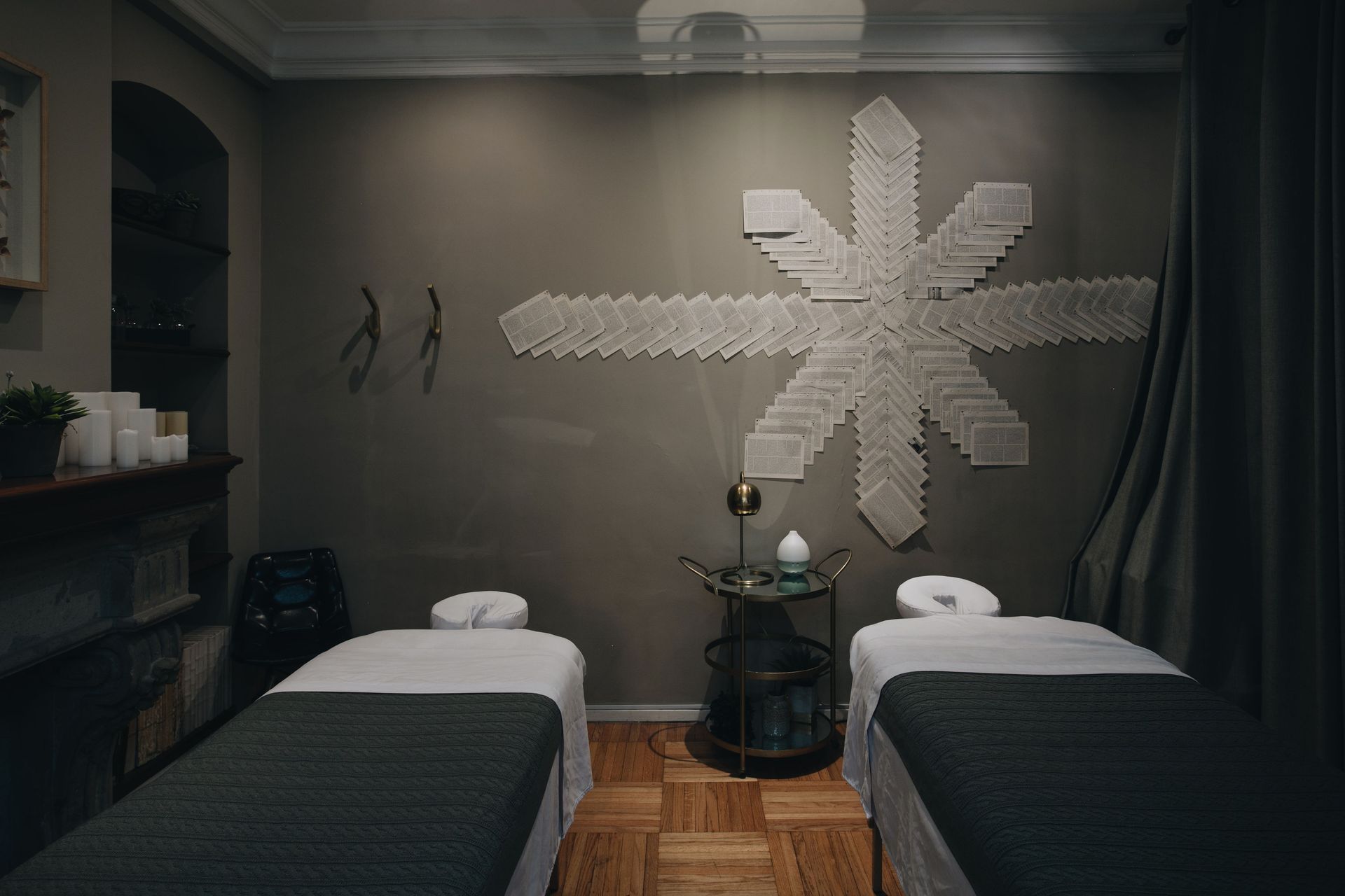 Two massage tables in a room with a star on the wall.