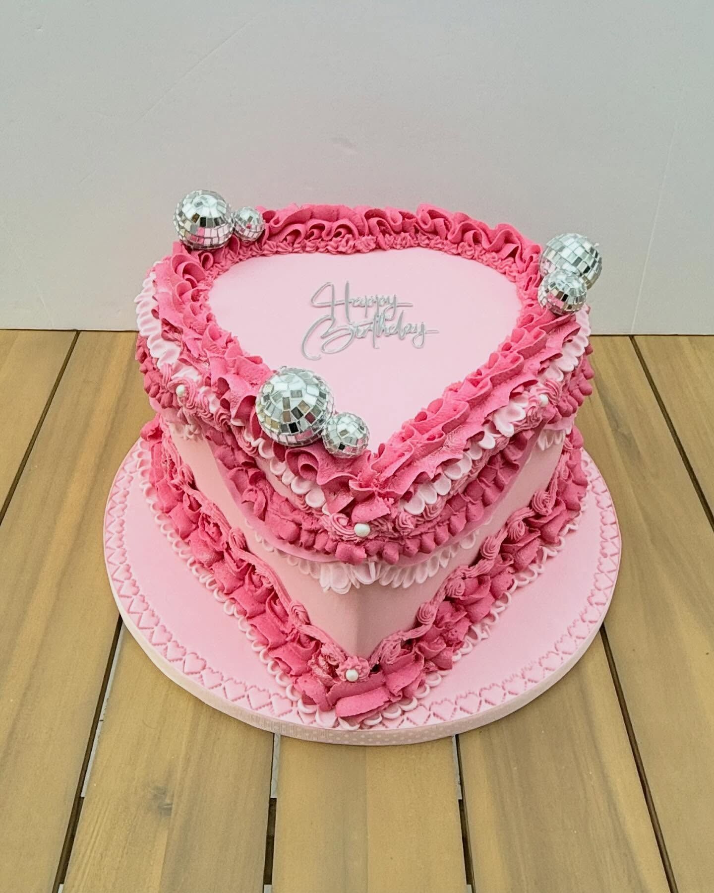 Heart-shaped cake with pink frosting