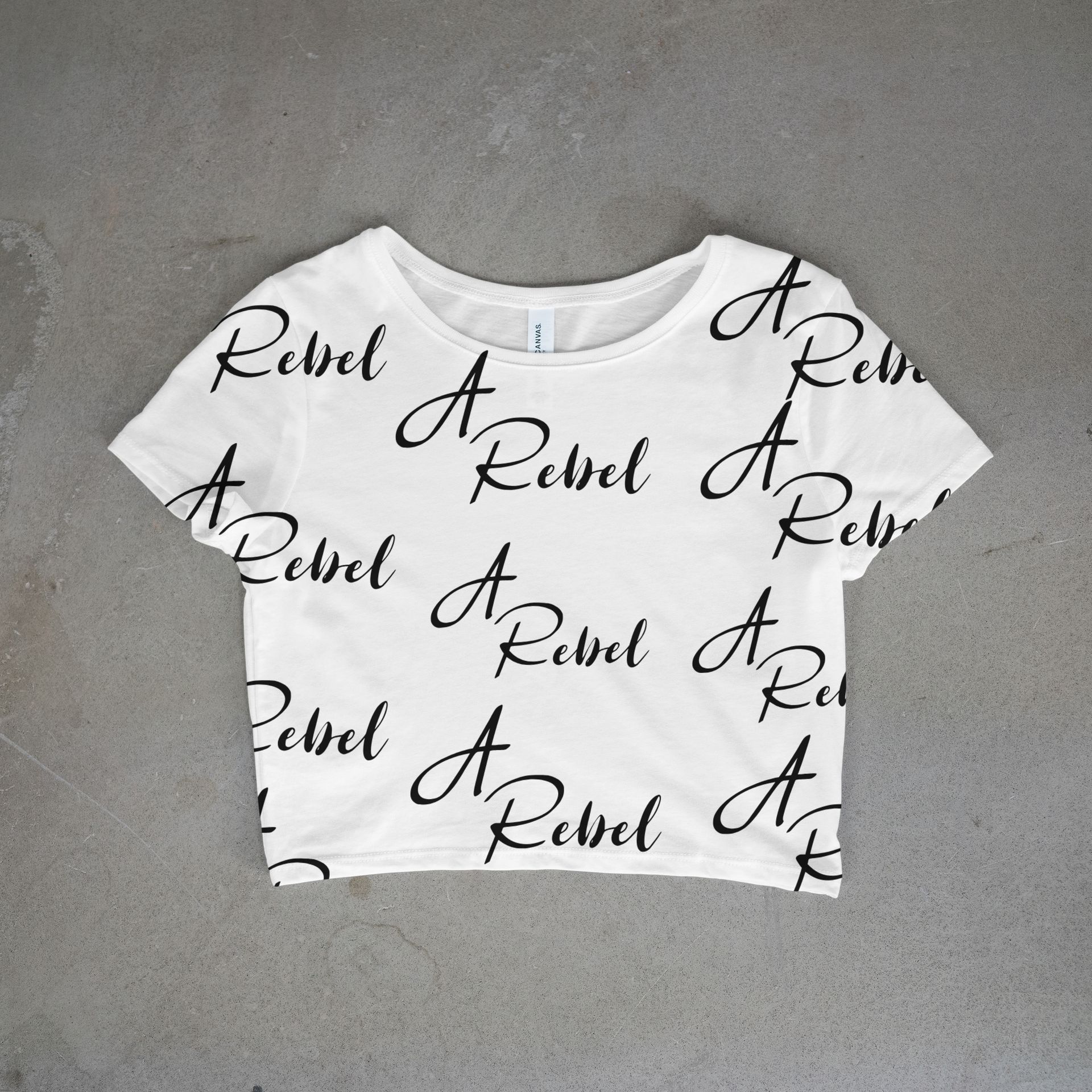 White cropped t-shirt with black cursive saying A Rebel all over front and back