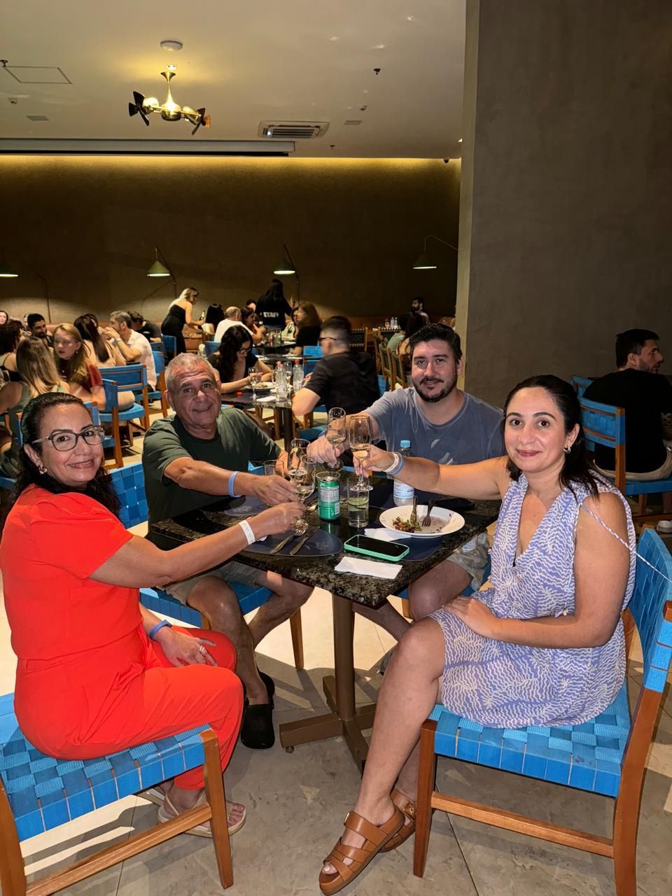 Um grupo de pessoas está sentado à mesa em um restaurante.