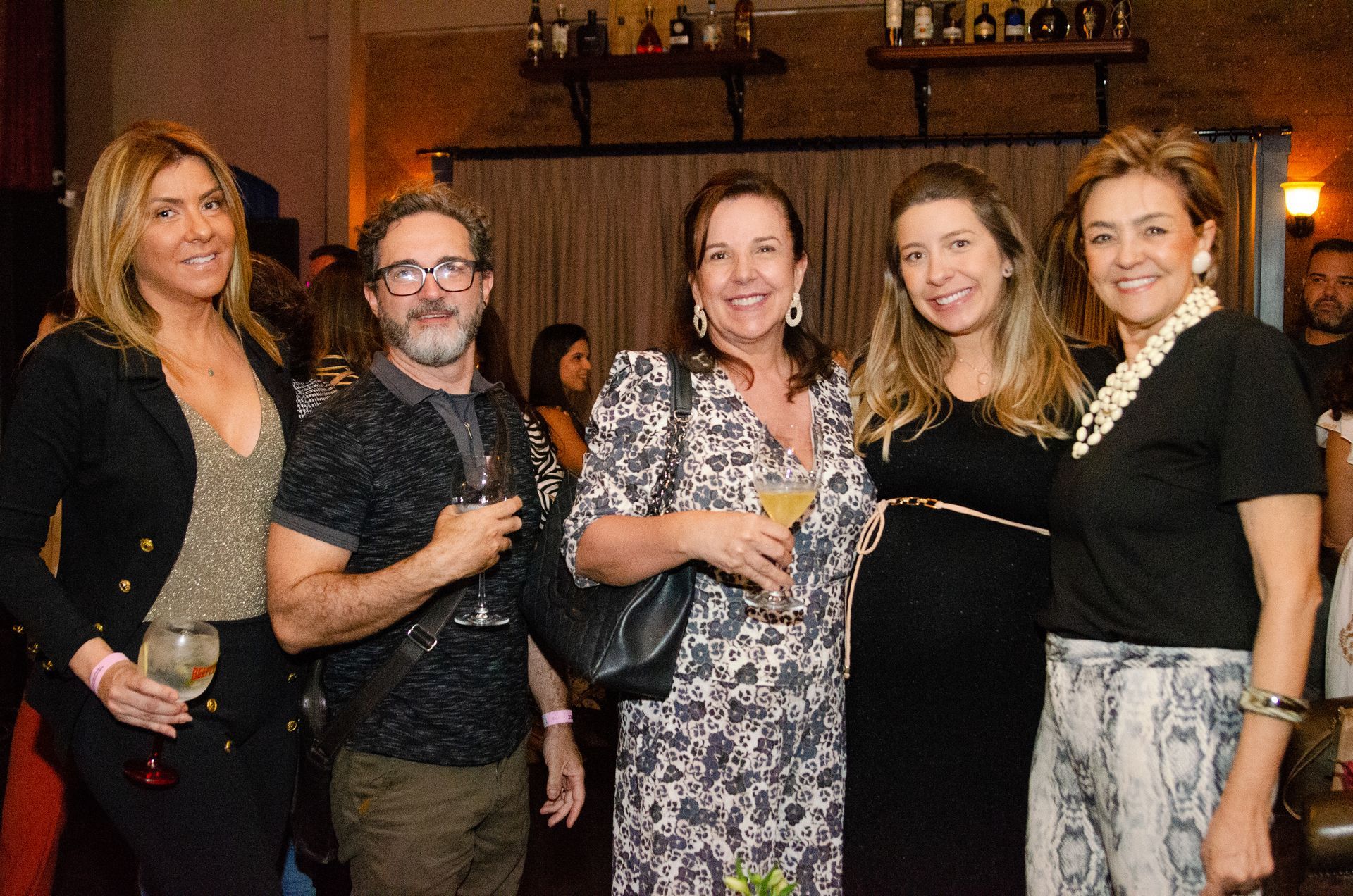 Um grupo de pessoas está posando para uma foto em uma sala.