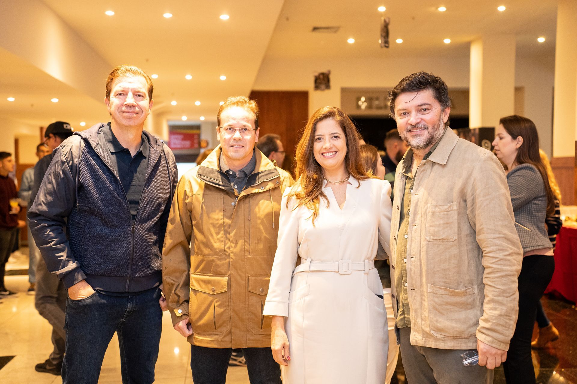 Um grupo de pessoas está posando para uma foto em uma sala.