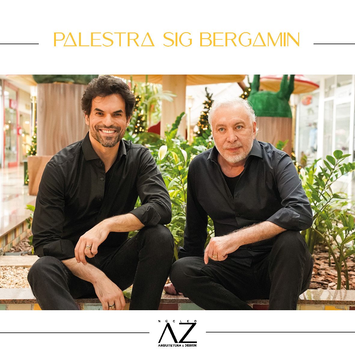 Dois homens de camisa preta estão sentados um ao lado do outro.