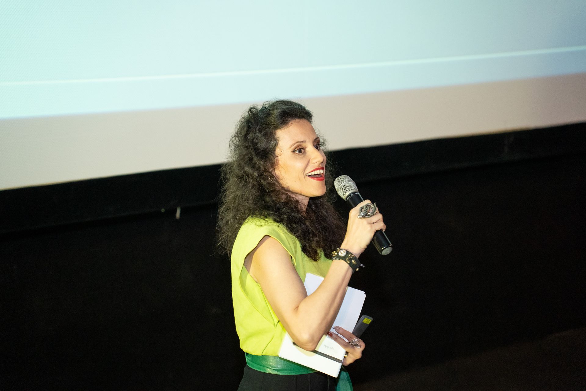 Uma mulher está em frente a uma placa que diz arquitetu e design