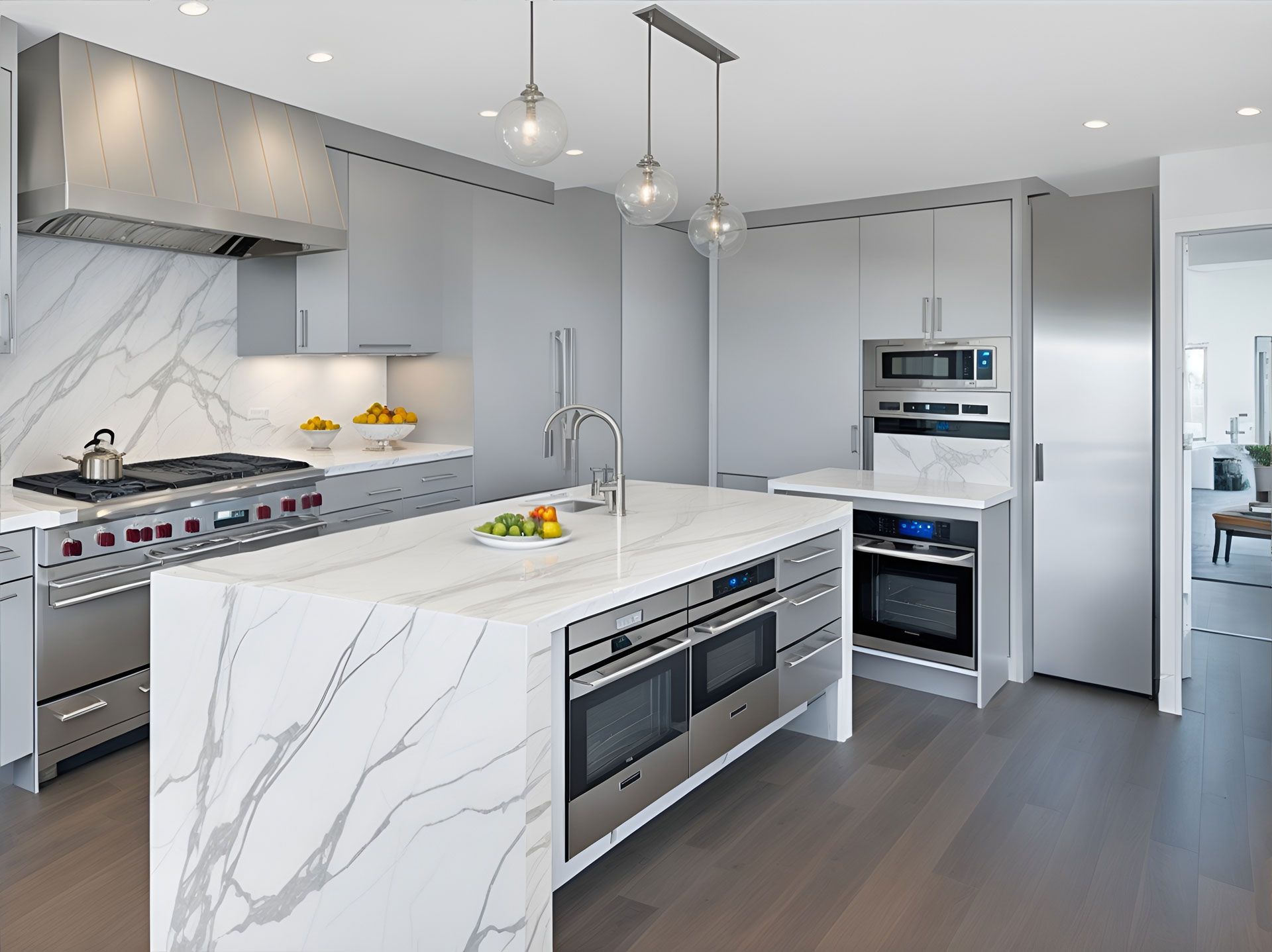 Modern gray and white kitchen with island, stainless steel appliances, and marble countertops.