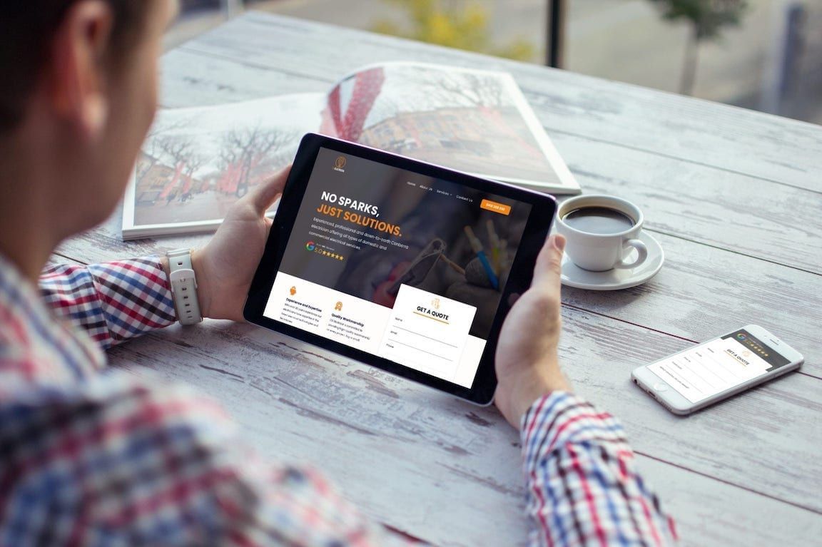 two men are sitting on the floor using a laptop computer .