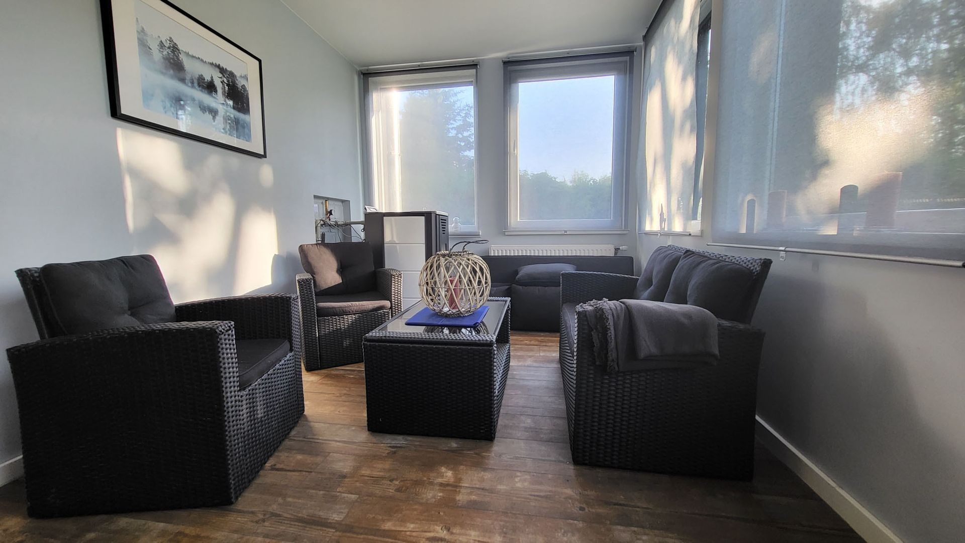 A living room with a couch , chairs , and a coffee table.
