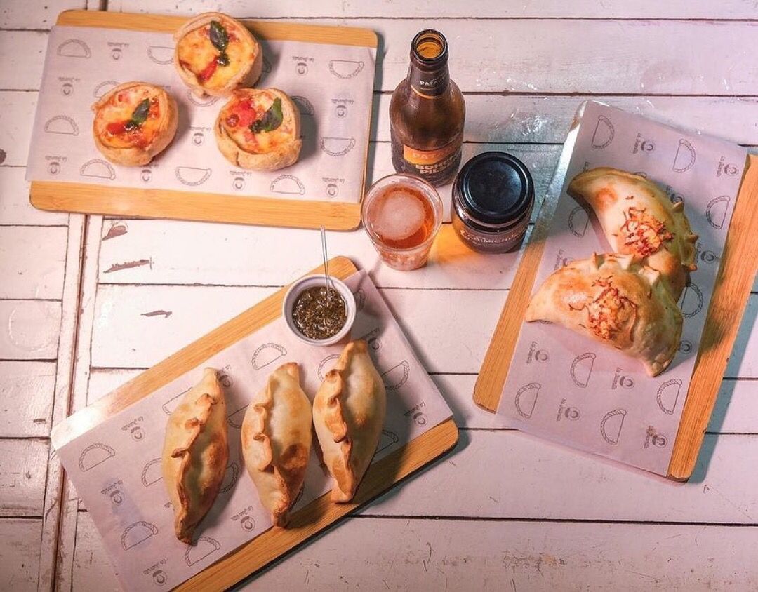 Uma mesa coberta com pratos de comida e uma garrafa de cerveja