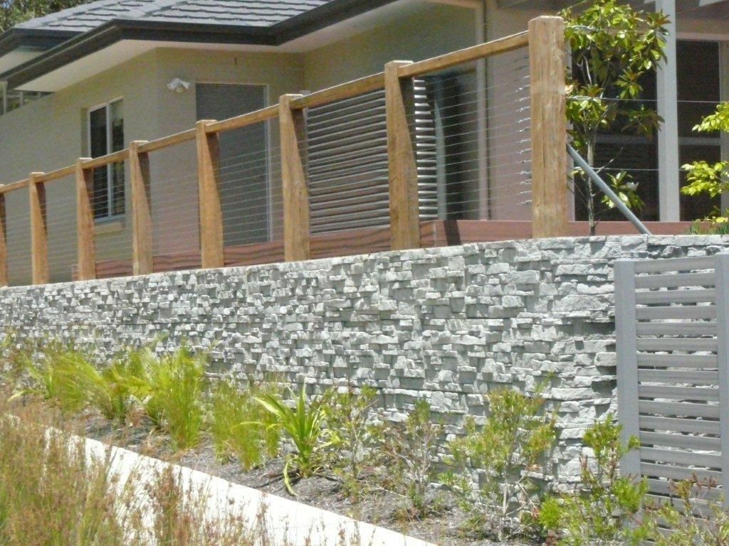 A Grey Concrete Profile Retaining Wall With Timber And Steel Fence In Front Of House — Bennett's Environmental In South Nowra, NSW