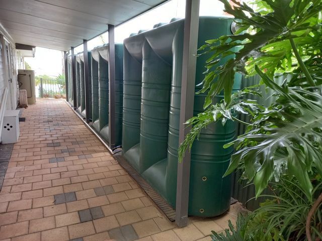 A Black Water Tank Is On The Roof Of A Building With A View Of The Ocean — Bennett's Environmental In South Nowra, NSW