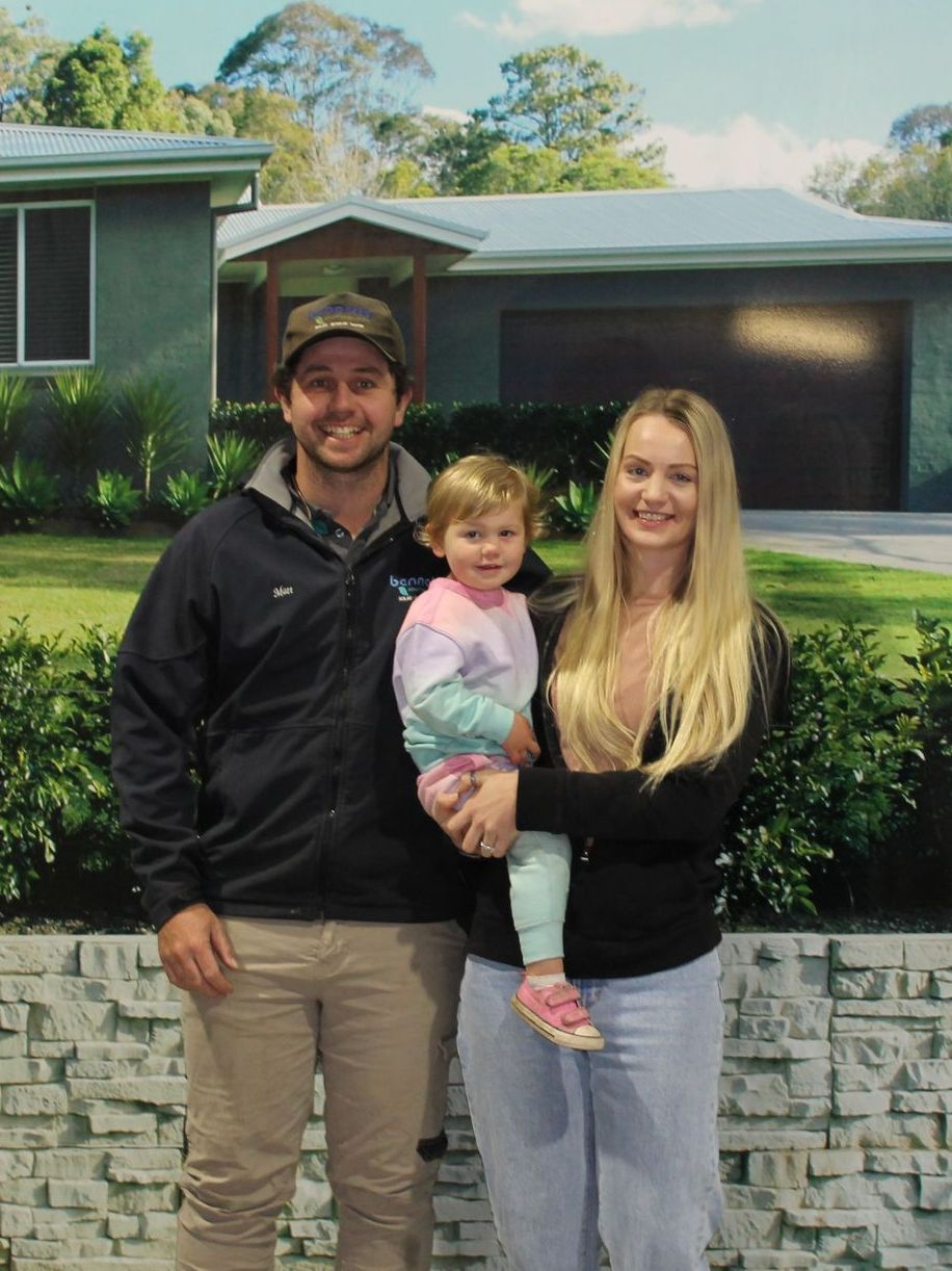 A Man Is Standing In Front Of A Bulldozer In A Dirt Field — Bennett's Environmental In South Nowra, NSW
