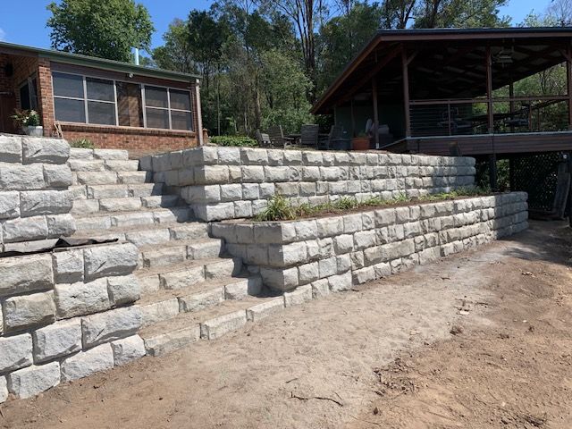 A Brick Wall Is Along The Side Of A Road — Bennett's Environmental In South Nowra, NSW