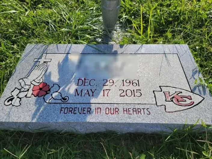 A gravestone with the words `` forever in our hearts '' written on it.