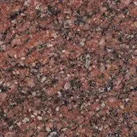 A close up of a red granite counter top.