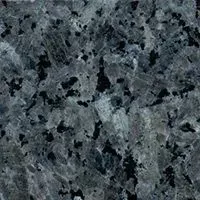 A close up of a gray granite counter top with black spots.