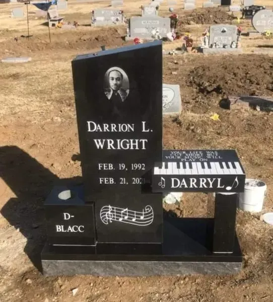 A gravestone for darrion l. wright with a piano on top