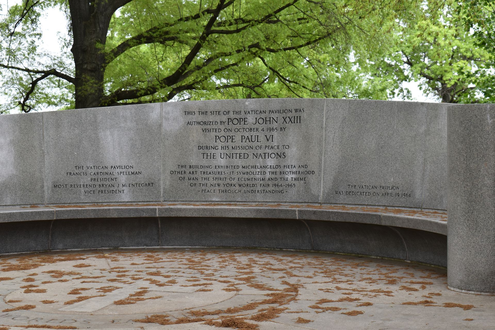 A concrete wall with arches and bricks on it